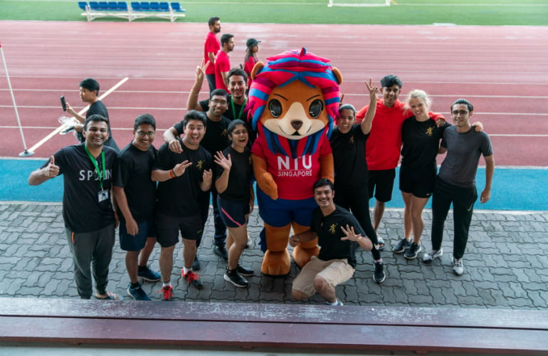 SP Jain students pose for a picture with the mascot