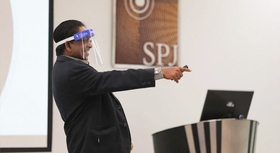 Faculty members use a face shield when conducting a lecture 